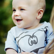 Baby boy smiling while looking to the side