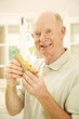 Photo: Senior man holding a sandwich Senior man holding a sandwich