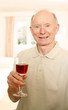 Photo: Senior man holding a glass of red wine Senior man holding a glass of red wine