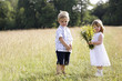 Little boy and little girl in the field