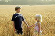 Brother holding sister's hand