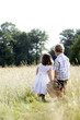 Photo: Little girl and little boy carrying a basket of flowers Little girl and little boy carrying a basket of flowers