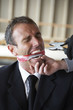 Kidnapper threatening businessman with a plier