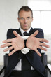 Businessman sitting on chair with his wrist tied up