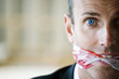 Terrified looking man with gagged mouth
