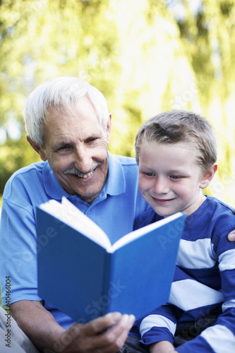 Photo: Grandfather and grandson sharing a book Grandfather and grandson sharing a book