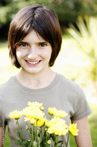 Photo: Girl holding a bouquet of flowers Girl holding a bouquet of flowers