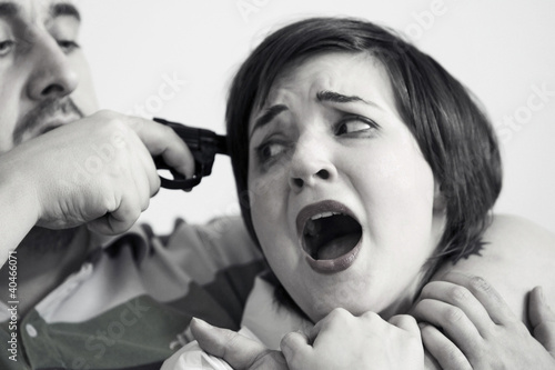 Photo: Man holding gun to woman's head Man holding gun to woman's head