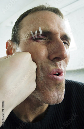 Photo: Man getting a punch on his face Man getting a punch on his face