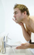 Man applying shaving cream on his face