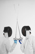 Two men in fencing suits in a duel