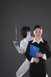 Photo: Businesswoman posing with a man in the background Businesswoman posing with a man in the background