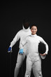 Photo: Man and woman in fencing suits posing for the camera Man and woman in fencing suits posing for the camera