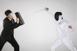 Photo: Businessman using his briefcase to block another man's attack Businessman using his briefcase to block another man's attack