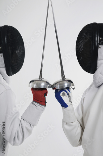 Photo: Two men in fencing suits in a duel Two men in fencing suits in a duel