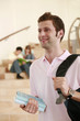 Man carrying bagpack while two people are having discussion in the background