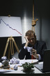 Businessman with a noose around his neck holding crumpled paper