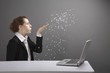 Businesswoman blowing confetti off her palm