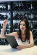 Woman raising her hand while holding menu