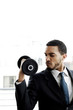 Businessman lifting dumbbell