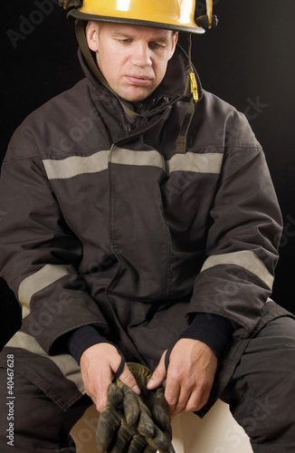 Photo: Fire fighter holding protective gloves Fire fighter holding protective gloves