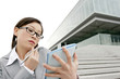 Foto: Businesswoman checking her organizer while talking on the phone Businesswoman checking her organizer while talking on the phone
