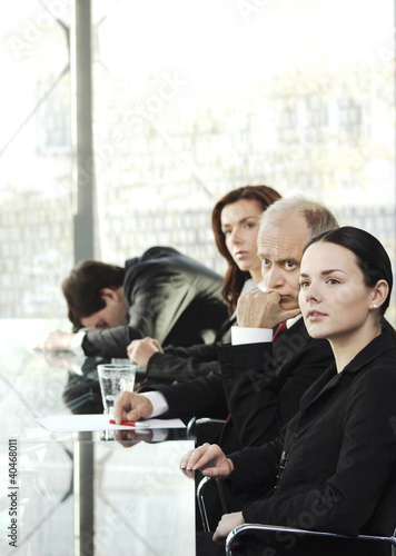 Photo: Businessman sleeping while the others are paying attention in the conference room Businessman sleeping while the others are paying attention in the conference room