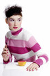 Woman holding a fork with an orange on the table