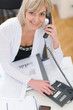 Photo: Smiling middle age business woman making phone call Smiling middle age business woman making phone call