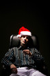 Foto: Businessman with christmas hat smoking cigarette Businessman with christmas hat smoking cigarette