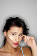 Woman with a plaster on her face crying