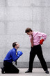 Businessman with boxing gloves begging for forgiveness