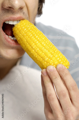 Photo: Man eating corn on cob Man eating corn on cob
