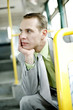 Businessman daydreaming while sitting in the bus