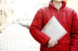 Photo : Man in red jacket holding a file Man in red jacket holding a file