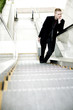 Businessman standing on the escalator thinking