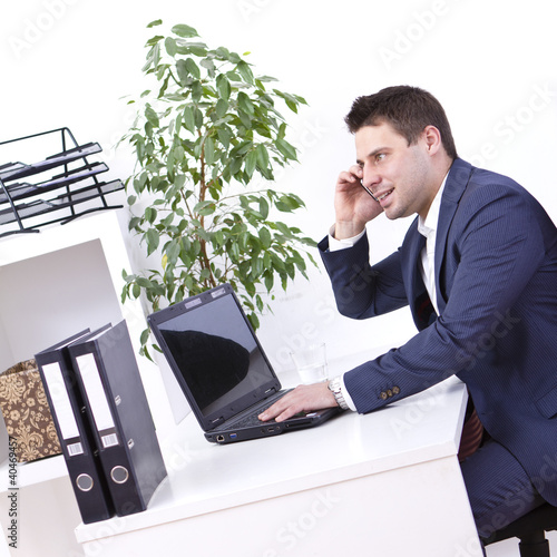 Photo: Successful businessman using cellphone Successful businessman using cellphone