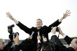Businessman calming down reporters at a press conference