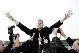Businessman calming down reporters at a press conference