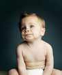 Baby boy in diaper looking up