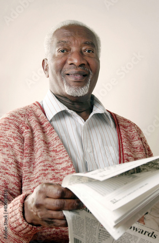Photo: Senior man reading newspaper Senior man reading newspaper