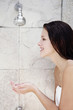 Photo: Woman cupping water from the shower Woman cupping water from the shower