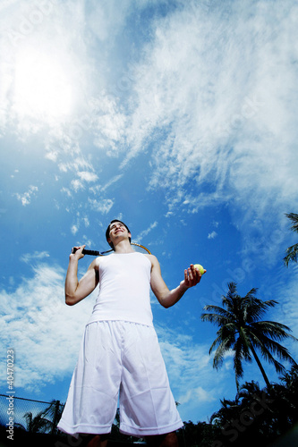 Photo: Man holding tennis racquet and ball Man holding tennis racquet and ball