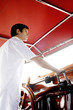Man at helm of yacht