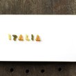 Some alphabet pasta being arranged into a word