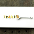 Some alphabet pasta being arranged into a word
