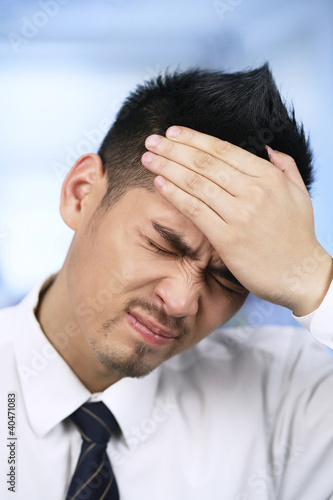 Photo: Businessman with his hand on forehead Businessman with his hand on forehead