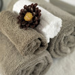 Scented candle on rolled up towels