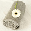 White flower on a rolled up towel