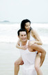 Man carrying his girlfriend on his back